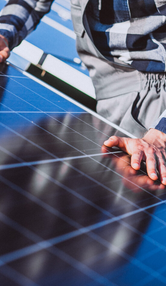 Man worker in the firld by the solar panels